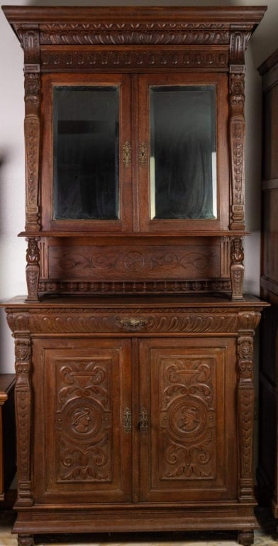 FRENCH RENAISSANCE REVIVAL VINTRINE BUFFET: French Renaissance Revival vitrine buffet with beveled mirror, carved galleries, and figural carved accents. Approximate dimensions: h. 92", w. 48", d. 19.5" Disclaimer: This is an online court ordere