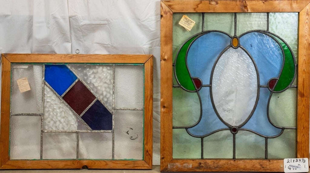 TWO CONTINENTAL STAINED GLASS PANELS: Two Continental stained glass panels with floral and geometric motifs. Approximate dimensions: h. 24.5", w. 21" Disclaimer: This is an online court ordered bankruptcy sale. Participating bidders must