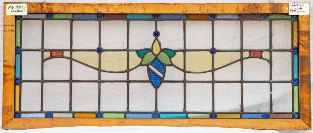 FRENCH ART NOUVEAU STAINED GLASS PANEL: French Art Nouveau stained glass panel with a floral medallion and a textured blue stained glass detail. Approximate dimensions: h. 22", w. 52" Disclaimer: This is an online court ordered bankruptcy s