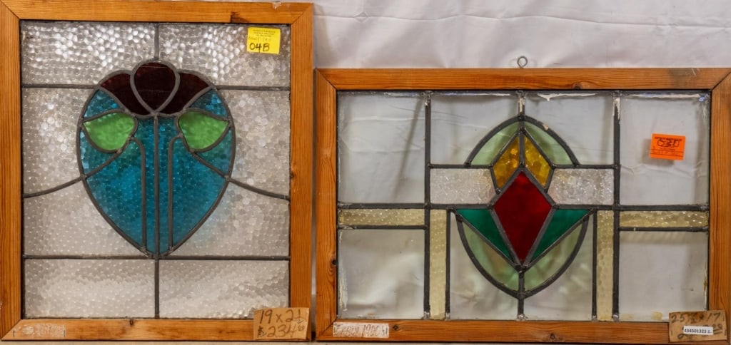TWO CONTINENTAL STAINED GLASS PANELS: Two Continental stained glass panels, one with a heart-shaped floral medallion and the other with a geometric medallion. Approximate dimensions: h. 21", w. 19" Disclaimer: This is an online court orde