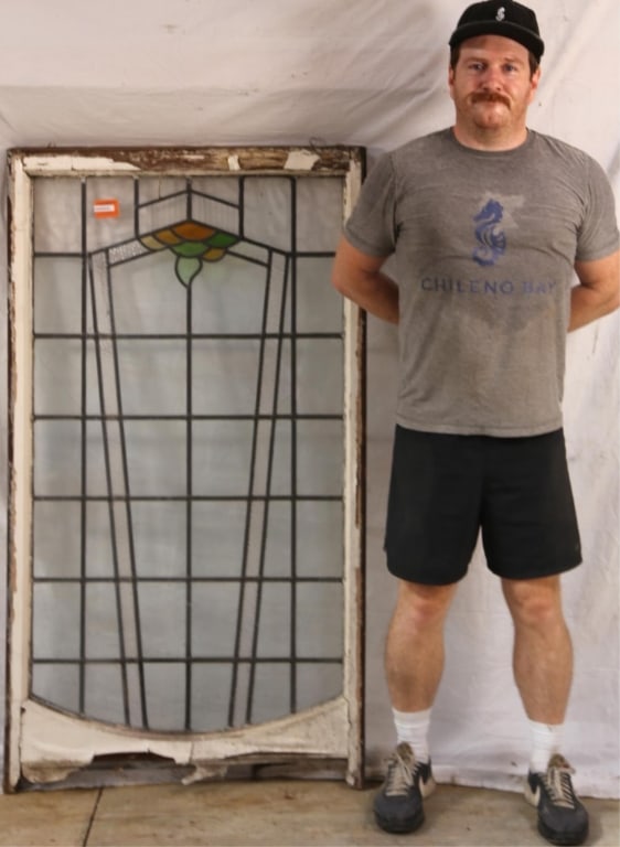 ENGLISH ART DECO STAINED GLASS PANEL: English Art Deco stained glass panel with geometric medallion in amber and green elements. Approximate dimensions: h. 56", w. 31" Disclaimer: This is an online court ordered bankruptcy sale. Participa