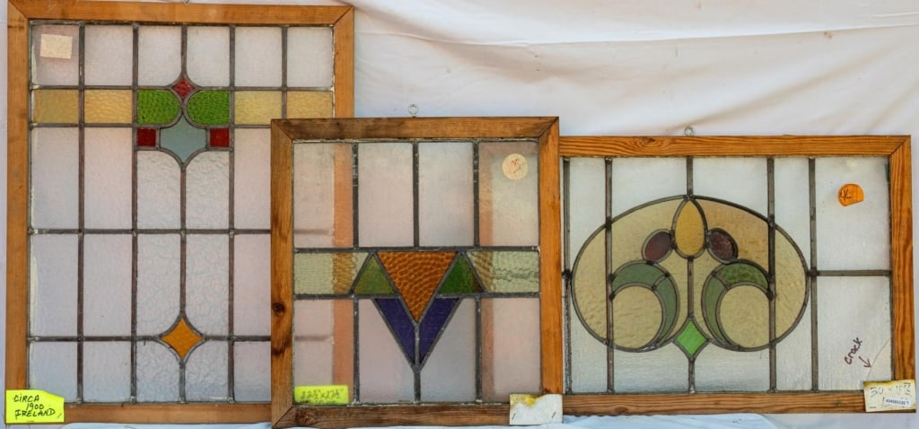 THREE FRENCH ART NOUVEAU STAINED GLASS PANELS: Two French Art Nouveau stained glass panels with multicolored stained glass ornamentation. Approximate dimensions: h. 27.5", w. 22.5" Disclaimer: This is an online court ordered bankruptcy sale. Parti