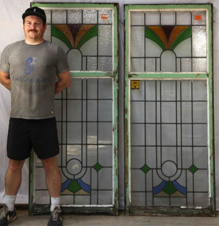 PAIR OF ANTIQUE CONTINENTAL STAINED GLASS PANELS: Pair of antique Continental stained glass panels with multicolored geometric elements, some with bubble-textured details. Approximate dimensions: each: h. 69", w. 29" Disclaimer: This is an online cou