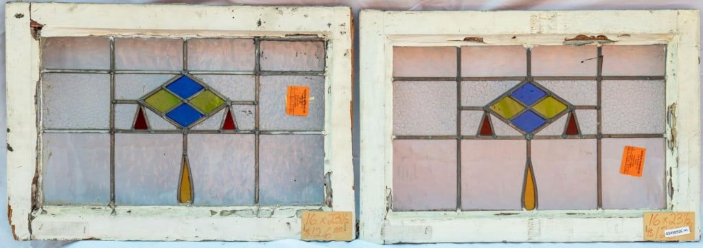 PAIR OF FRENCH ART DECO STAINED GLASS PANELS: Pair of French Art Deco stained glass panels with yellow, blue, and red geometric stained glass details. Approximate dimensions: h. 16", w. 23.5" Disclaimer: This is an online court ordered bankruptcy