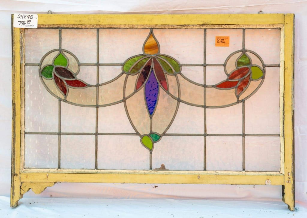 FRENCH ART NOUVEAU STAINED GLASS PANEL: French Art Nouveau stained glass panel with a floral motif in purple, green, and red stained glass. Approximate dimensions: h. 24", w. 40" Disclaimer: This is an online court ordered bankruptcy sale.