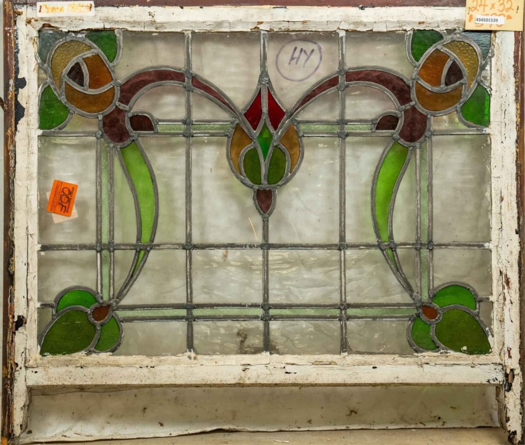 FRENCH ART NOUVEAU STAINED GLASS PANEL: French Art Nouveau stained glass panel with a drop-shaped central medallion and floral and botanical details at the corners. Approximate dimensions: h. 24", w. 32" Disclaimer: This is an online court