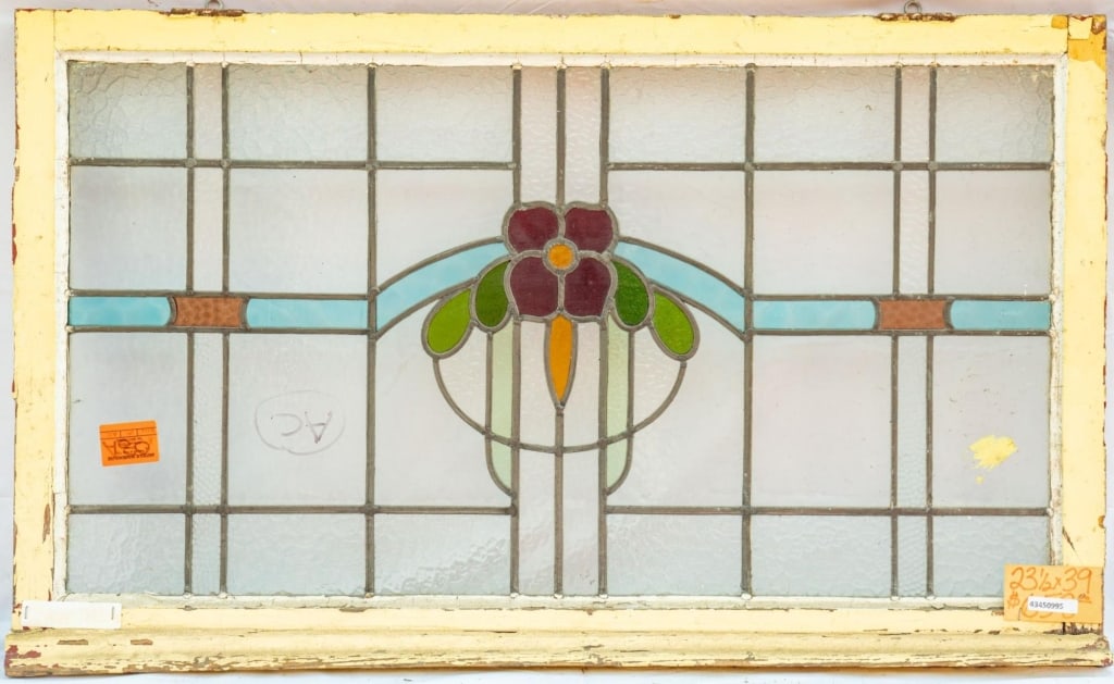 FRENCH ART NOUVEAU STAINED GLASS PANEL: French Art Nouveau stained glass panel with red flower and green leaf details set within colorless leaded glass panels. Approximate dimensions: h. 23", w. 39" Disclaimer: This is an online court order