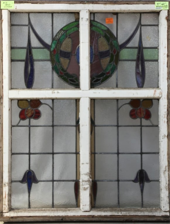 ENGLISH ART NOUVEAU STAINED GLASS PANEL: English Art Nouveau stained glass panel with wreath motif medallion and floral elements. Approximate dimensions: h. 60", w. 47" Disclaimer: This is an online court ordered bankruptcy sale. Participati