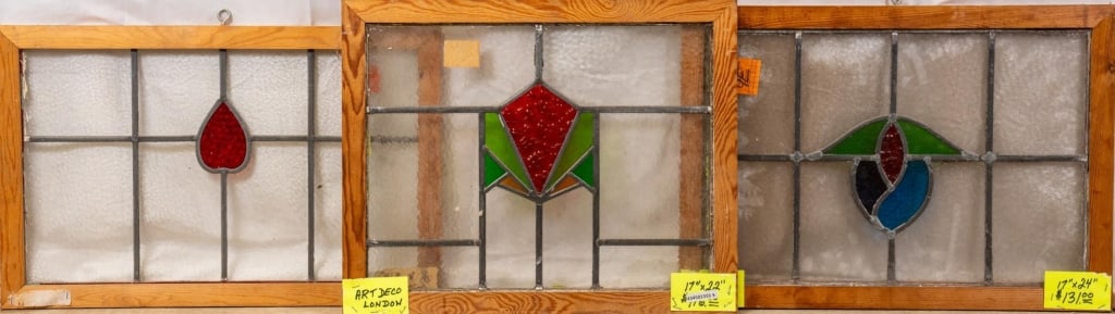 THREE ENGLISH STAINED GLASS PANELS: Three English stained glass panels with floral and geometric motifs. Approximate dimensions: h. 17", w. 22" Disclaimer: This is an online court ordered bankruptcy sale. Participating bidders must have