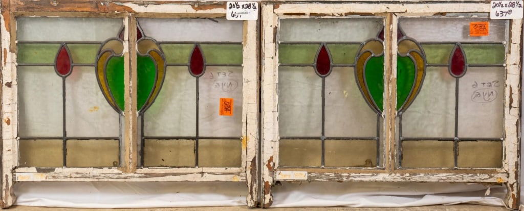 PAIR OF CONTINENTAL STAINED GLASS PANELS: Pair of Continental stained glass panels with a heart-shaped central medallion and two red drop accents. Approximate dimensions: h. 20.5", w. 28.5" Disclaimer: This is an online court ordered bankrupt
