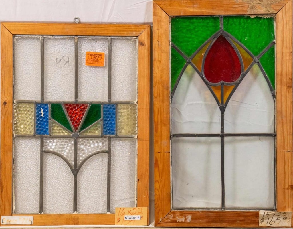 TWO CONTINENTAL STAINED GLASS PANELS: Two Continental stained glass panels, one with a geometric medallion and the other with a heart-shaped medallion. Approximate dimensions: h. 25", w. 15" Disclaimer: This is an online court ordered ban
