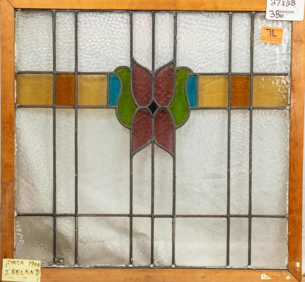 ANTIQUE CONTINENTAL STAINED GLASS PANEL: Antique Continental stained glass panel with a floral medallion and amber accented stained glass panels. Approximate dimensions: h. 28", w. 27" Disclaimer: This is an online court ordered bankruptcy s