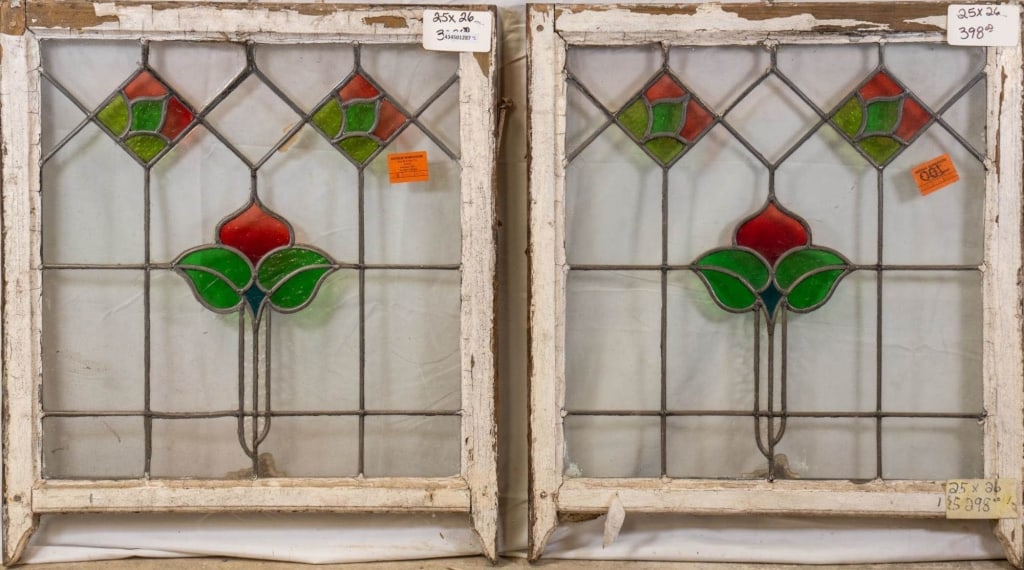 PAIR OF ENGLISH STAINED GLASS PANELS: Pair of English stained glass panels with a floral motif and textured green glass accents. Approximate dimensions: h. 26", w. 25" Disclaimer: This is an online court ordered bankruptcy sale. Participa