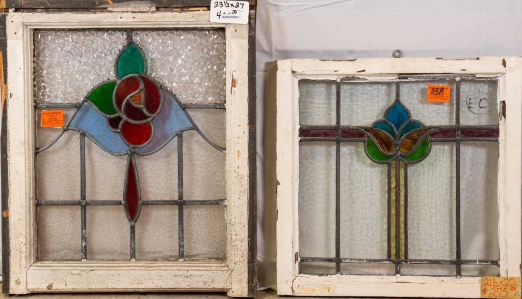 TWO FRENCH ART NOUVEAU STAINED GLASS PANELS: Two French Art Nouveau stained glass panels, one with a floral medallion and textured colorless panel accents, and the other with a floral medallion and wispy glass accents. Approximate dimensions: h.