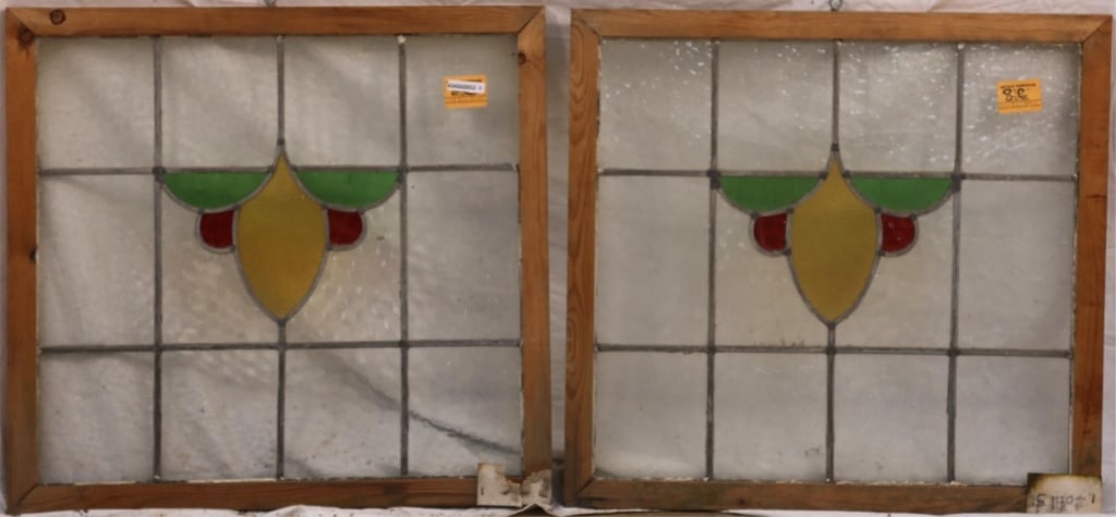 PAIR OF ANTIQUE CONTINENTAL STAINED GLASS PANELS: Pair of antique Continental stained glass panels with central medallion in canary yellow, green, and red. Approximate dimensions: h. 24", w. 25" Disclaimer: This is an online court ordered bankruptcy