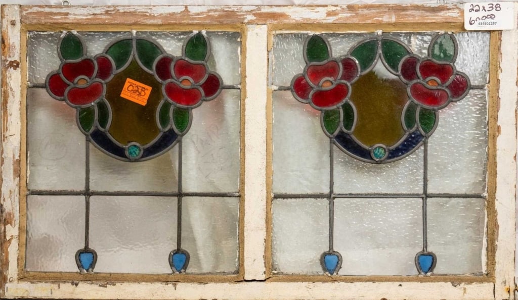 PAIR OF FRENCH ART NOUVEAU STAINED GLASS PANELS: Pair of French Art Nouveau stained glass panels with floral medallions and blue accent details at the bottom. Approximate dimensions: h. 22", w. 38" Disclaimer: This is an online court ordered bankrup