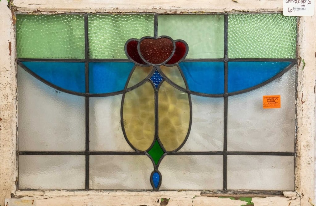 FRENCH ART NOUVEAU STAINED GLASS PANEL: French Art Nouveau stained glass panel with a floral medallion and blue and green textured accents. Approximate dimensions: h. 24.5", w. 36.5" Disclaimer: This is an online court ordered bankruptcy sa