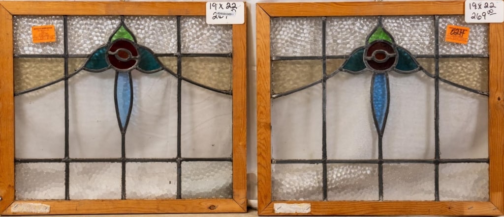 PAIR OF CONTINENTAL STAINED GLASS PANELS: Pair of Continental stained glass panels with central rose medallions surrounded by leaf and blue accents. Approximate dimensions: h. 19", w. 22" Disclaimer: This is an online court ordered bankruptcy