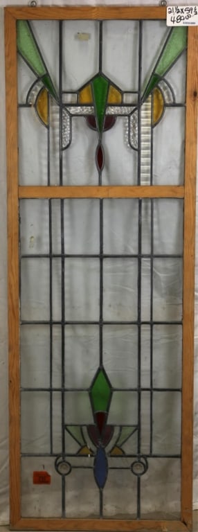 FRENCH ART DECO STAINED GLASS PANEL: French Art Deco stained glass panel with elaborate geometric stained glass details in amber, green, red, blue, and purple, and textured colorless leaded glass panels. Approximate dimensions: h. 59.5",