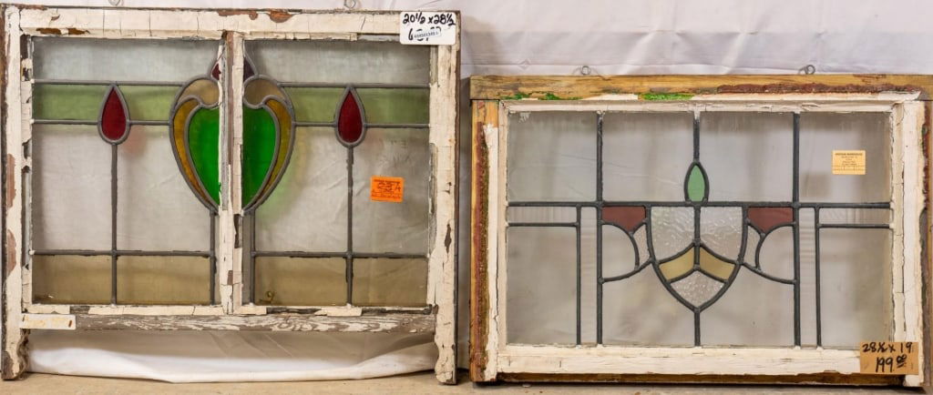 TWO ANTIQUE CONTINENTAL STAINED GLASS PANELS: Two antique Continental stained glass panels, one with a heart-shaped medallion with red drop accents and the other with a shield medallion with red and green accents. Approximate dimensions: h. 20.5"