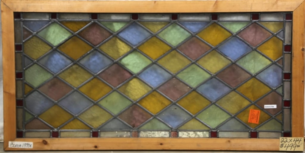 ANTIQUE ENGLISH STAINED GLASS PANEL: Antique English stained glass panel with multicolored rhombic glass elements. Approximate dimensions: h. 22", w. 44" Disclaimer: This is an online court ordered bankruptcy sale. Participating bidders