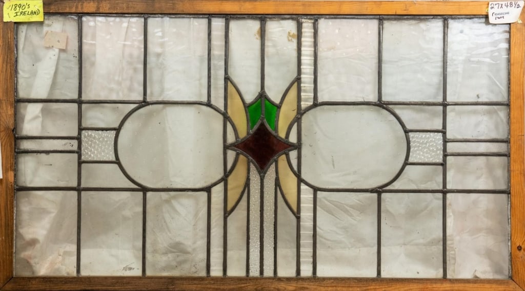 IRISH ART DECO STAINED GLASS PANEL: Irish Art Deco stained glass panel with a geometric medallion. Approximate dimensions: h. 27", w. 48.5" Disclaimer: This is an online court ordered bankruptcy sale. Participating bidders must have a c