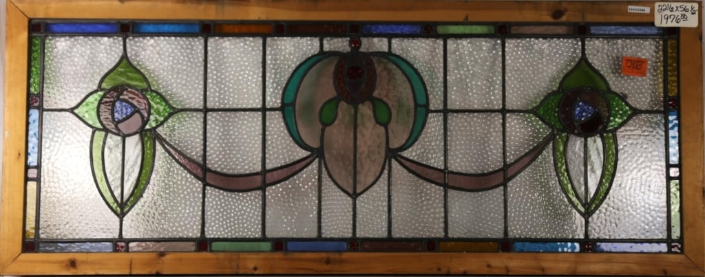 FRENCH ART NOUVEAU JEWELED STAINED GLASS PANEL: French Art Nouveau jeweled stained glass panel with red jeweled detail and floral medallion. Approximate dimensions: h. 22.5", w. 56.5" Disclaimer: This is an online court ordered bankruptcy sale. Par