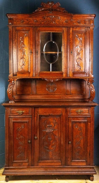 FRENCH ART NOUVEAU VITRINE BUFFET: French Art Nouveau vitrine buffet with carved crest, inset carved panels, carved supports, beveled glass door cabinet, and carved rosette on backsplash. Approximate dimensions: h. 96", w. 51", d. 21" 