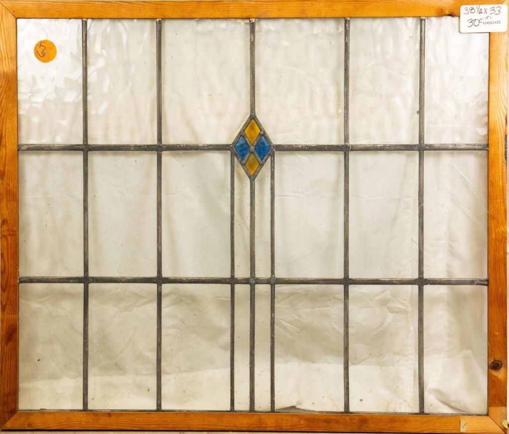 ENGLISH ART DECO STAINED GLASS PANEL: English Art Deco stained glass panel with a textured blue and yellow rhombic medallion. Approximate dimensions: h. 33", w. 38.5" Disclaimer: This is an online court ordered bankruptcy sale. Participat