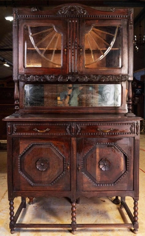 FRENCH ART NOUVEAU MIRRORED BUFFET: French Art Nouveau mirrored buffet with carved appliques, beveled mirror backsplash, beveled glass cabinet doors, and carved supports. Approximate dimensions: h. 80", w. 46", d. 19" Disclaimer: This i