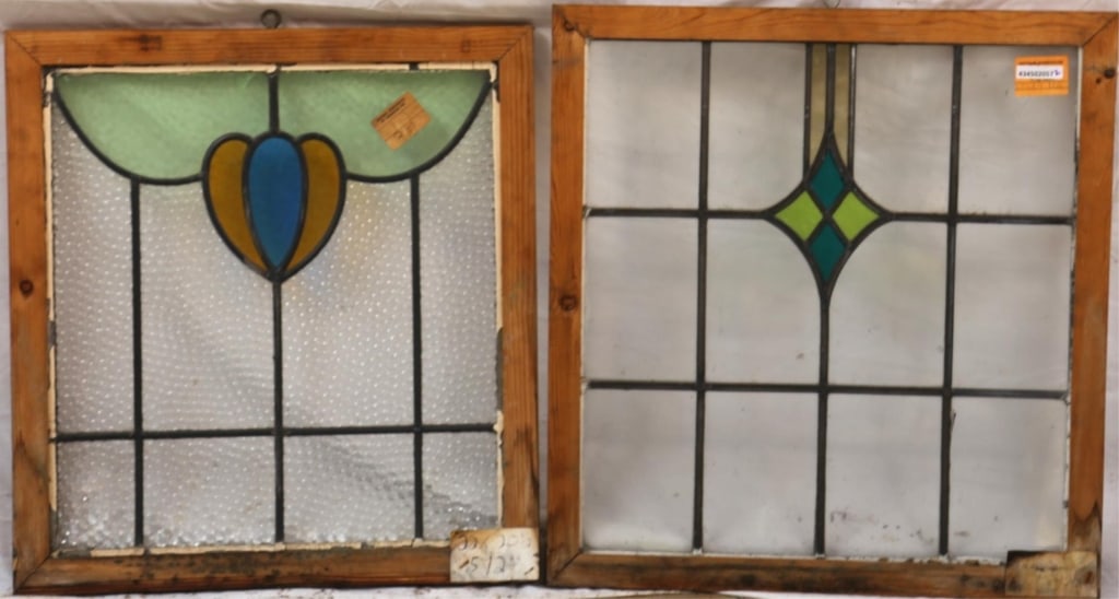 TWO ANTIQUE CONTINENTAL STAINED GLASS PANELS: Two antique Continental stained glass panels, one with rhombic medallion, another with floral motif in blue and yellow. Approximate dimensions: h. 22", w. 20" Disclaimer: This is an online court order