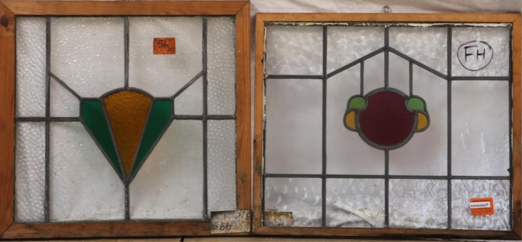 TWO ANTIQUE CONTINENTAL STAINED GLASS PANELS: Two antique Continental stained glass panels, one with round purple medallion with yellow and green accents, another with geometric amber and green medallion. Approximate dimensions: h. 21", w. 22" Di