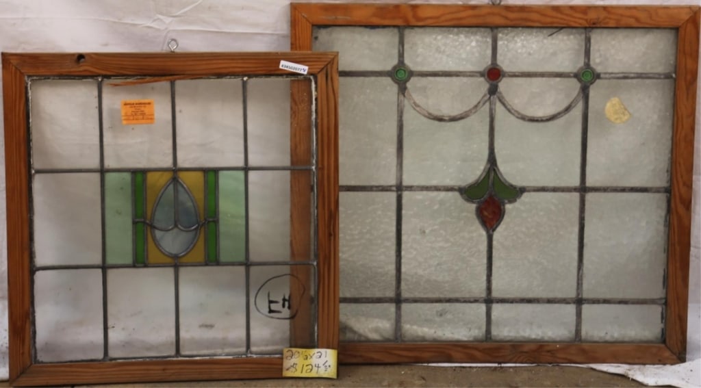TWO ANTIQUE ENGLISH STAINED GLASS PANELS: Two antique English stained glass panels, one with a jeweled floral medallion and wispy glass, another with a blue wispy glass medallion. Approximate dimensions: h. 24", w. 26" Disclaimer: This is an