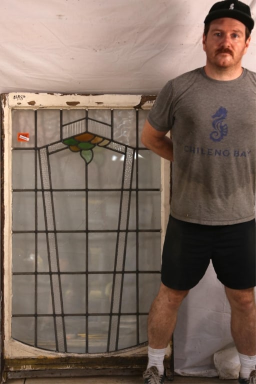 ENGLISH ART DECO STAINED GLASS PANEL: English Art Deco stained glass panel with a geometric amber and green central medallion, some colorless panels are textured. Approximate dimensions: h. 52", w. 32" Disclaimer: This is an online court