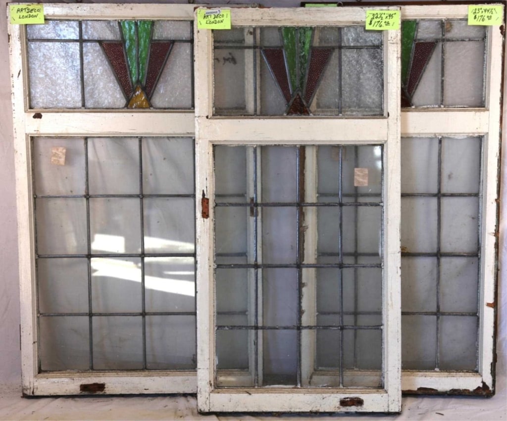 SET OF 3 ENGLISH ART DECO STAINED GLASS WINDOWS: Set of three English Art Deco stained glass windows with geometric medallions in purple, amber, and green. Approximate dimensions: h. 45", w. 22.5" Disclaimer: This is an online court ordered bankrupt