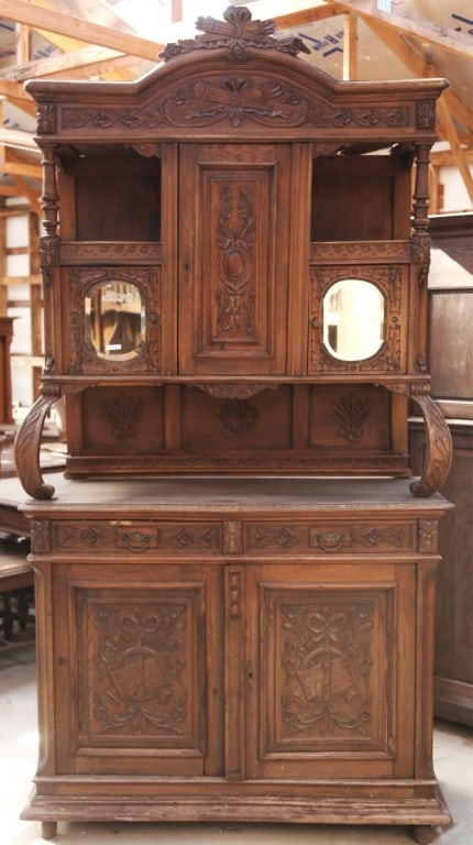 FRENCH ART NOUVEAU OAK VITRINE BUFFET: French Art Nouveau oak vitrine buffet with beveled mirrors, a carved backsplash, inset carved panels, and a carved crest. Approximate dimensions: h. 98", w. 52", d. 21" Disclaimer: This is an online c