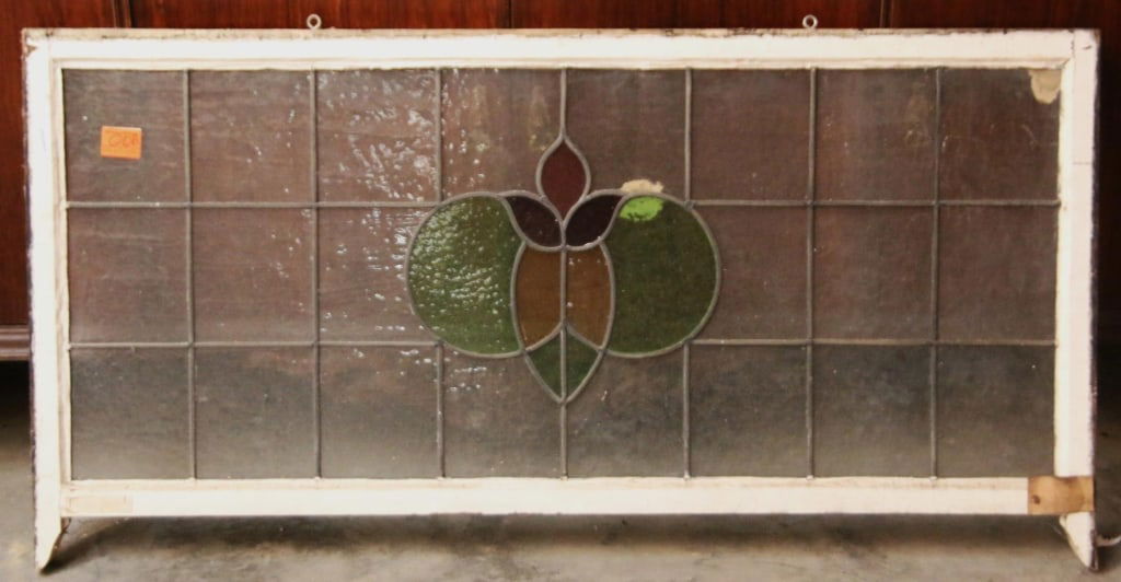 ANTIQUE CONTINENTAL STAINED GLASS PANEL: Antique Continental stained glass panel with an abstract medallion in multicolored stained glass. Approximate dimensions: h. 30", w. 56.5" Disclaimer: This is an online court ordered bankruptcy sale.