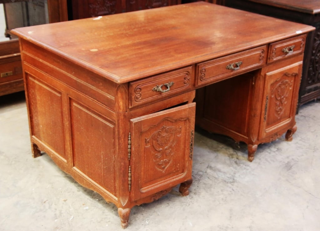 FRENCH OAK PARTNERS DESK: French oak partners desk with a carved apron and inset carved panels. Approximate dimensions: h. 31", w. 57", d. 38" Disclaimer: This is an online court ordered bankruptcy sale. Participating bidders