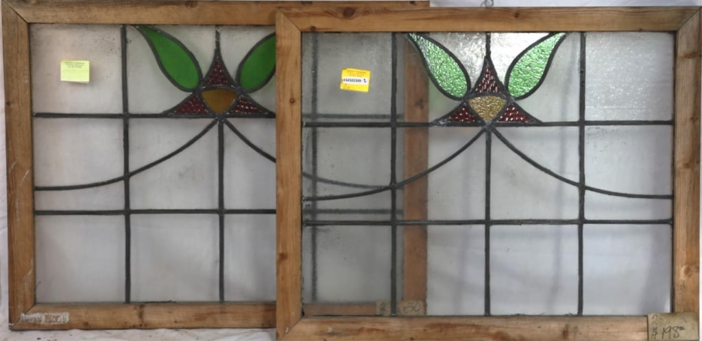 PAIR OF ENGLISH STAINED GLASS PANELS: Pair of English stained glass panels with floral motif medallions in amber, red, and green. Approximate dimensions: h. 23.5", w. 30" Disclaimer: This is an online court ordered bankruptcy sale. Partic