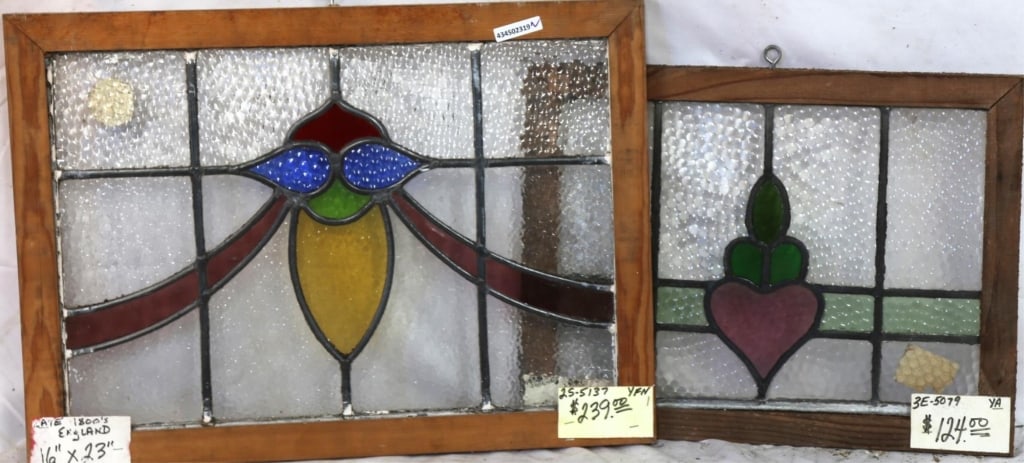 TWO ENGLISH STAINED GLASS PANELS: Two English stained glass panels with multicolored stained glass accents. Approximate dimensions: h. 16", w. 23" Disclaimer: This is an online court ordered bankruptcy sale. Participating bidders must