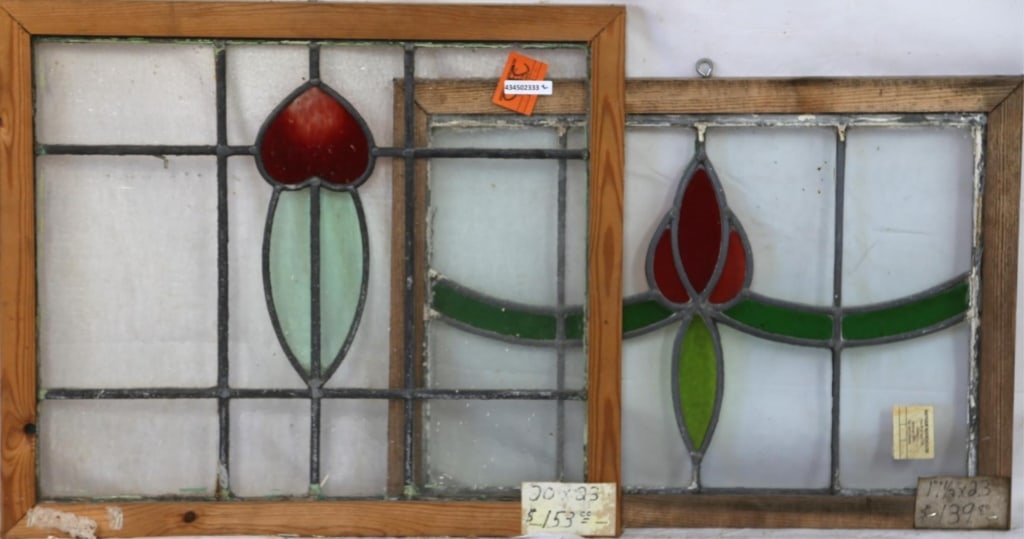 TWO CONTINENTAL STAINED GLASS PANELS: Two Continental stained glass panels with floral motif medallions in red and green. Approximate dimensions: h. 20", w. 23" Disclaimer: This is an online court ordered bankruptcy sale. Participating bi