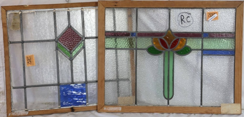 TWO CONTINENTAL STAINED GLASS PANELS: Two Continental stained glass panels with multicolored stained glass accents. Approximate dimensions: h. 21", w. 26" Disclaimer: This is an online court ordered bankruptcy sale. Participating bidders