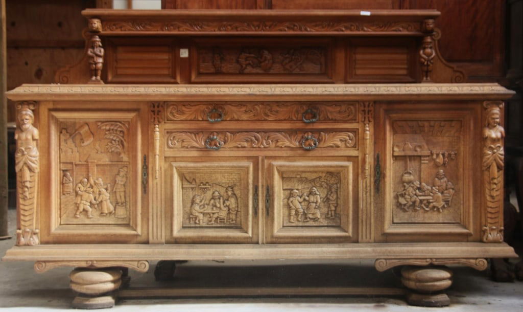 BELGIAN RENAISSANCE REVIVAL SIDEBOARD: Belgian Renaissance Revival sideboard with figural wood appliqués, adorned with intricately carved genre scenes on the cabinet doors. Approximate dimensions: h. 56", w. 89", d. 22" Disclaimer: This i