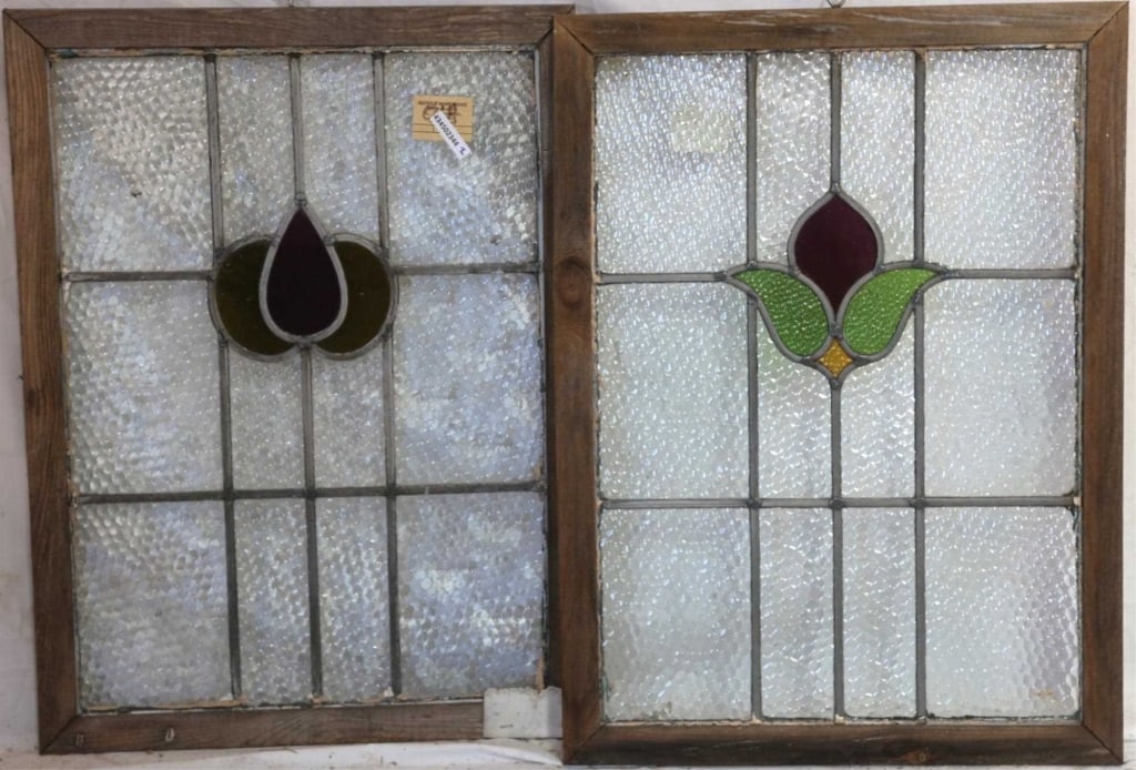 TWO CONTINENTAL STAINED GLASS PANELS: Two Continental stained glass panels with multicolored stained glass accents. Approximate dimensions: h. 22", w. 19" Disclaimer: This is an online court ordered bankruptcy sale. Participating bidders