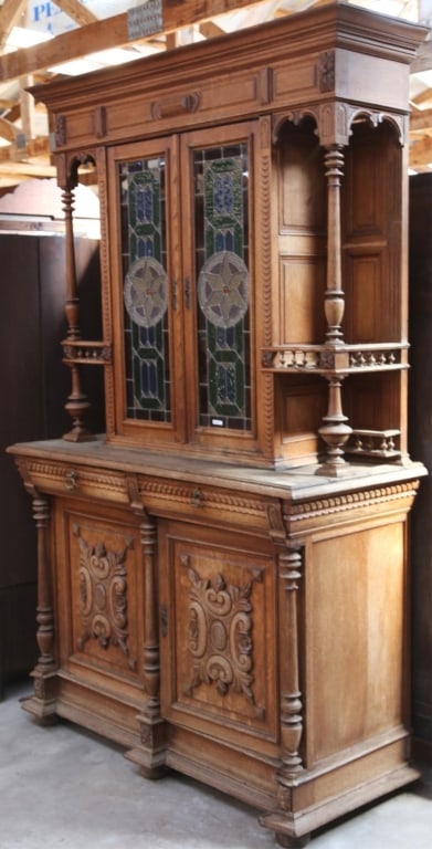 FRENCH RENAISSANCE REVIVAL STAINED GLASS BUFFET: French Renaissance Revival stained glass buffet with double stained glass panels with jeweled elements, lion and brass ring accents, and elaborate carving throughout. Approximate dimensions: h. 96", w