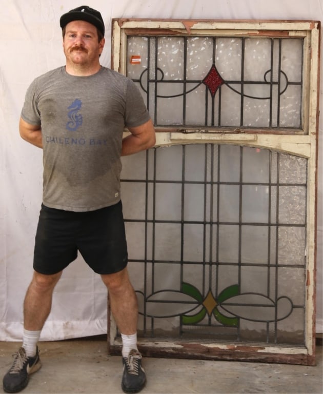 ANTIQUE CONTINENTAL STAINED GLASS PANEL: Antique Continental stained glass panel with textured rhombic and green and yellow details, some textured, and colorless leaded glass panels. Approximate dimensions: h. 65", w. 39" Disclaimer: This is