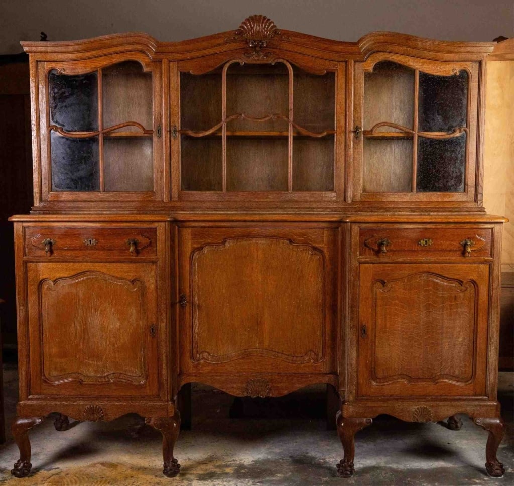 FRENCH OAK VITRINE SIDEBOARD: French oak vitrine sideboard with shell-carved crest and Chippendale influenced legs. Approximate dimensions: h. 69", w. 73", d. 21.5" Disclaimer: This is an online court ordered bankruptcy sale. Part