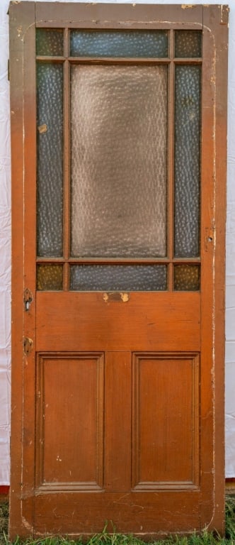 ANTIQUE STAINED GLASS DOOR: Antique stained glass door with blue, amber, and red textured glass panels. Approximate dimensions: h. 78", w. 31.5" Disclaimer: This is an online court ordered bankruptcy sale. Participating bidders