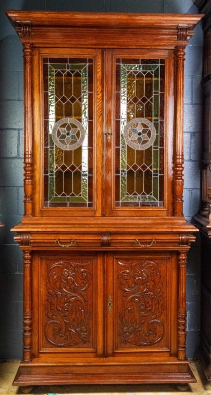 FRENCH RENAISSANCE REVIVAL STAINED GLASS BUFFET: French Renaissance Revival stained glass buffet with plinth base, stained and jeweled glass door panels, carved columns, and inset carved panels. Approximate dimensions: h. 92", w. 45", d. 23" Disclai