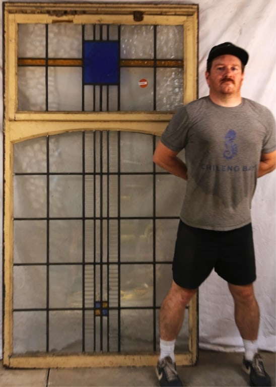 IRISH ART DECO STAINED GLASS PANEL: Irish Art Deco stained glass panel with a blue textured central rectangular element and amber stained glass stripe accent. Approximate dimensions: h. 72.5", w. 40" Disclaimer: This is an online court